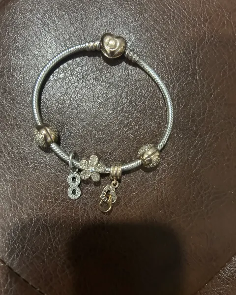 Se vende pulsera Pandora original con dejes de oro rosa